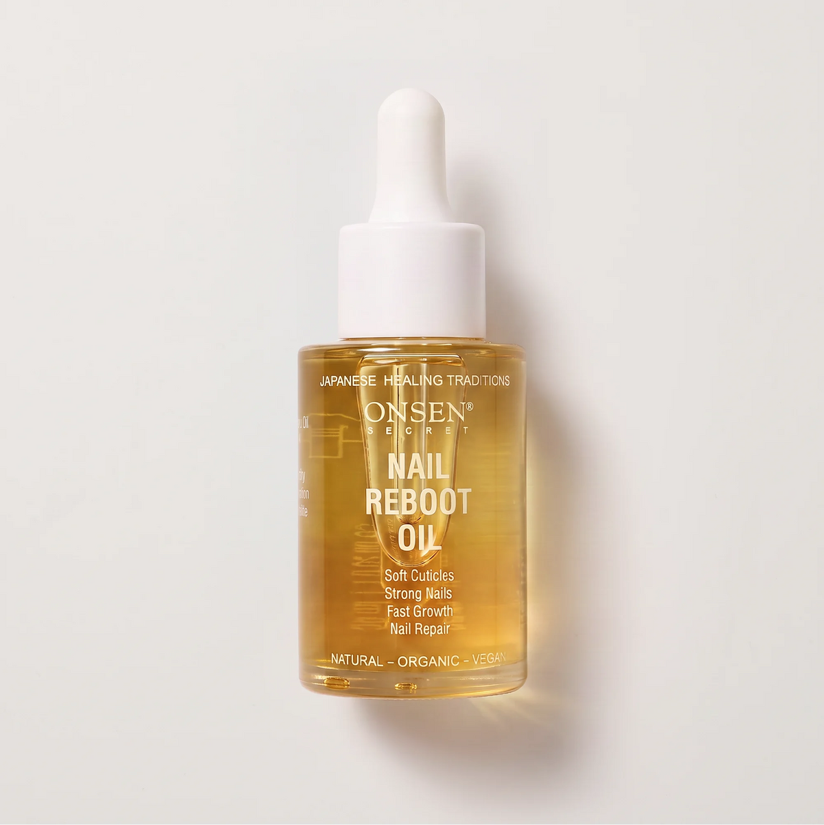 Onsen Secret Nail Reboot Oil, transparent dropper bottle with yellow liquid and label highlighting soft cuticles, strong nails, fast growth, and repair.