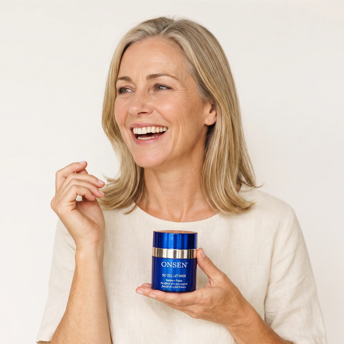 Onsen Secret Bio Cell Lift Mask, model holding blue skincare container with metallic accents highlighting non‑surgical facelift benefits.