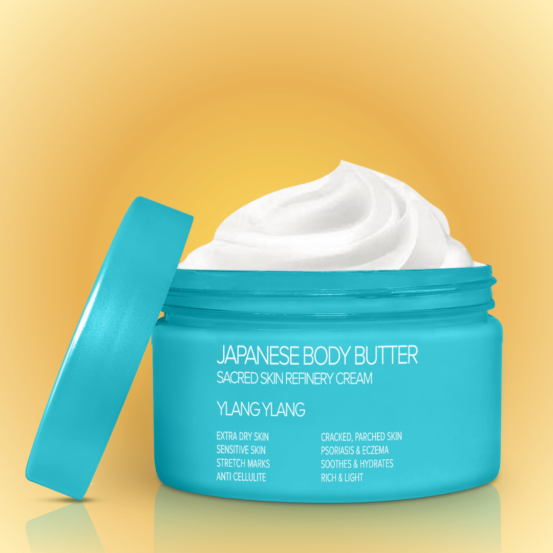 A jar of Japanese Body Butter with the lid off, showing the creamy texture of the product inside. The jar is labeled with the product name and benefits like &