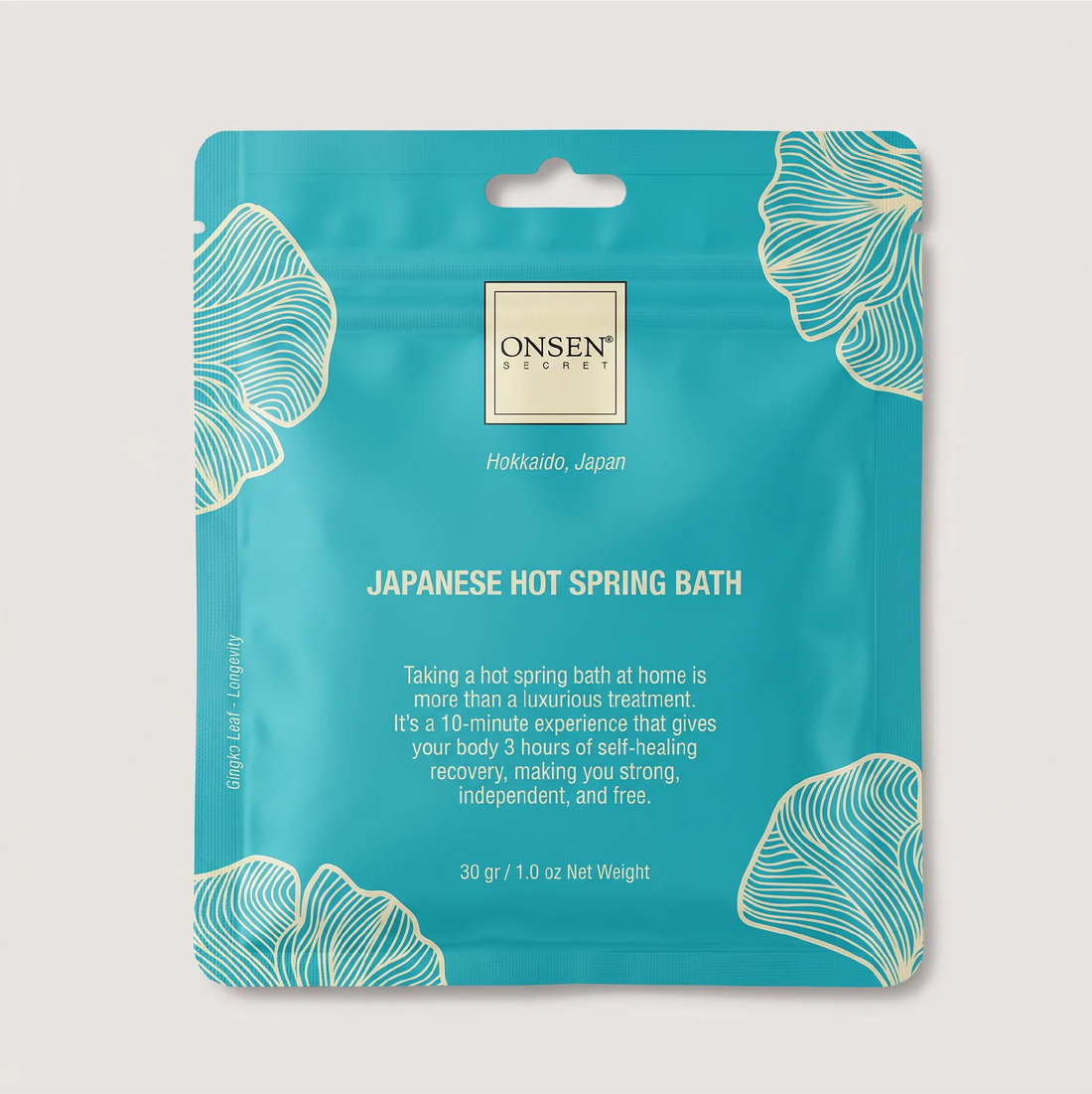 Onsen Secret Japanese Hot Spring Bath product, teal packaging with white ginkgo illustrations promoting relaxation and self‑care.
