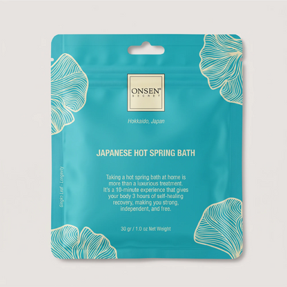 Onsen Secret Japanese Hot Spring Bath product, teal packaging with white ginkgo illustrations promoting relaxation and self‑care.