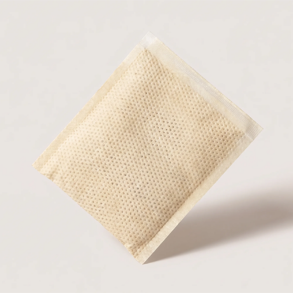 Skincare and wellness product visual, porous sachet packaging for Onsen Secret Japanese hot spring bath treatment.