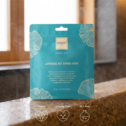 Onsen Secret Japanese Hot Spring Bath, teal package with spa background highlighting vegan, cruelty free, and SLS‑free qualities.
