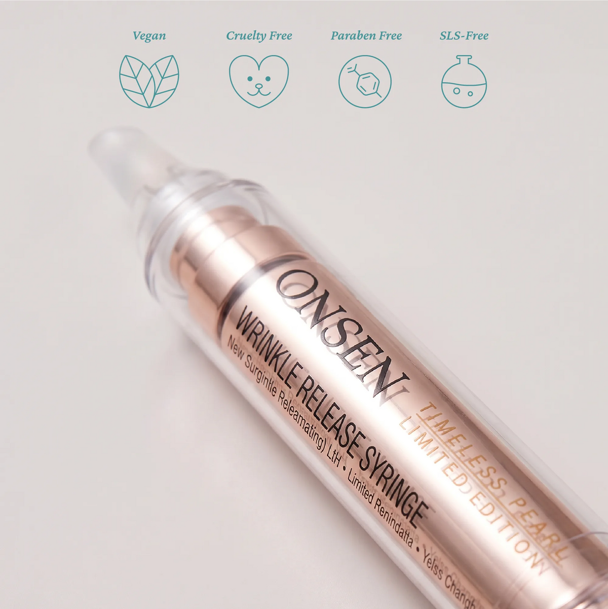 Anti‑aging skincare product packaging, Onsen Secret wrinkle release syringe limited edition in metallic rose‑gold design highlighting clean beauty attributes.