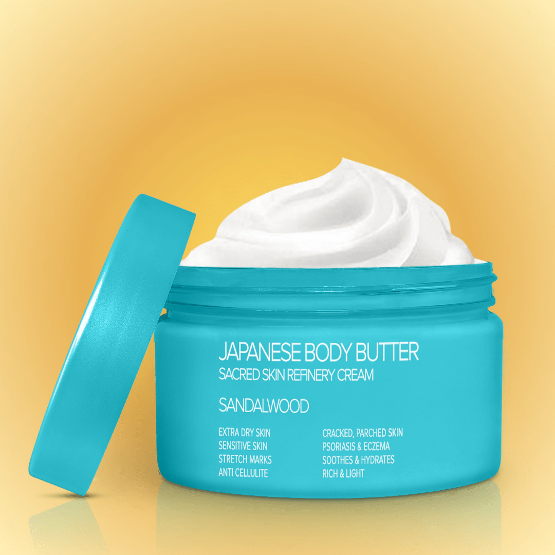 A jar of Japanese Body Butter with the lid off, showing the creamy texture of the product inside. The jar is labeled with the product name and benefits like &