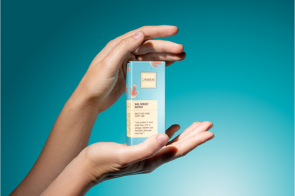 Hand holding a clear container with a blue gradient background